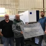 Shop Crew holding perforated panel